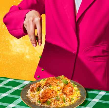 Sprinkling spice onto biryani dish